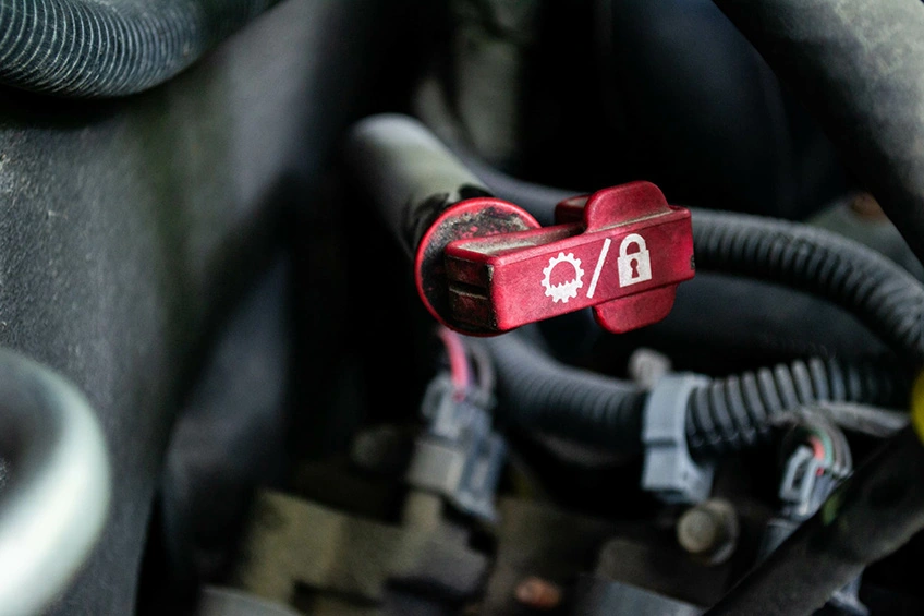 A dipstick for measuring the level of gearbox oil in a vehicle, seen under the bonnet.